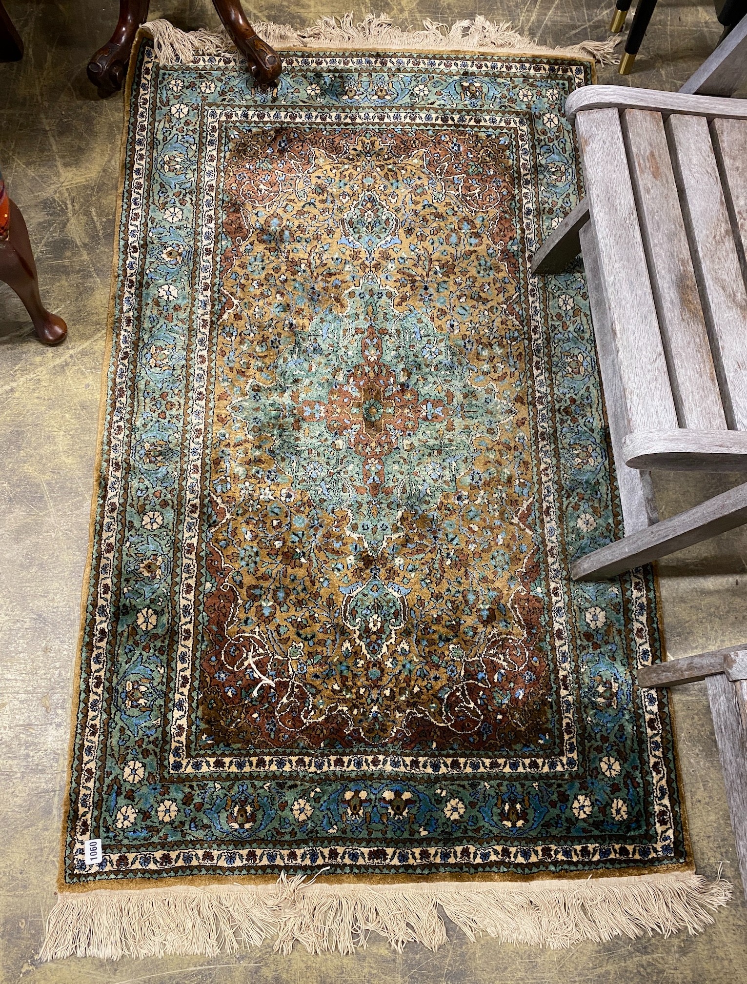 A North West Persian green ground rug, 150 x 90cm